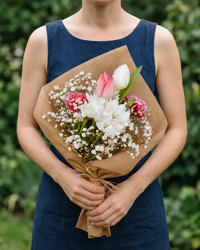 Example with sample flowers: a wrapped bouquet in the Navy bouquet · garden room, kept as made